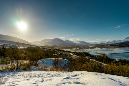 Sunny Winter Landscape in Iceland with Snow and Blue Sky near Akの写真素材