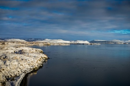 Frozen Lake with Volcano blue Sky and Snow reflection white in Iの写真素材
