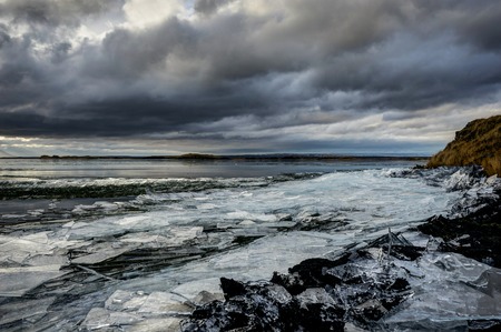 Winter Landscape frozen lake with ice floes and cloudy sky in Ic