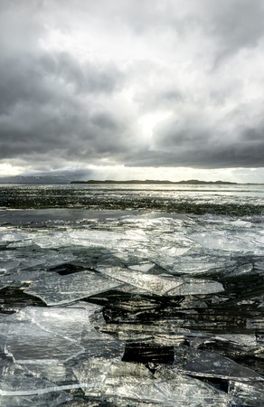 Winter Landscape frozen lake with ice floes and cloudy sky in Icの写真素材