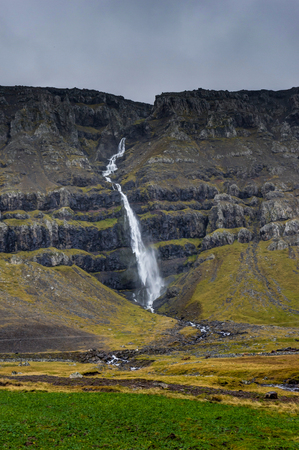 Hegifoss Waterfall in Iceland with mountains and cloudy sky mistの写真素材