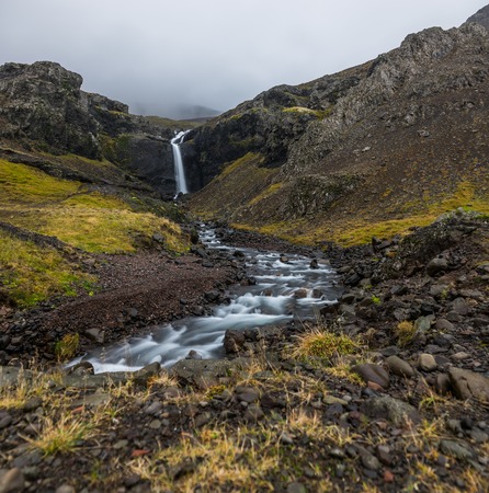 Hegifoss Waterfall in Iceland with mountains and river long expoの写真素材