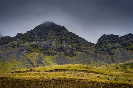 Icelandic Landscape with fog mountains with snow covered in fogの写真素材