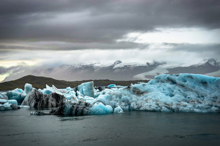 Icebergs floating in Jokulsarlon glacier lake at sunset in Icela