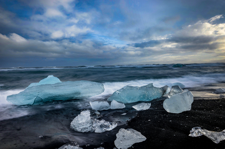 Icebergs floating in Jokulsarlon glacier lake at sunset in Icelaの写真素材