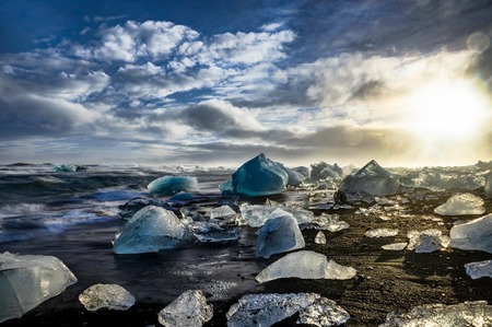 Icebergs floating in Jokulsarlon at sunset golden hour with glacの写真素材