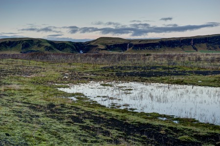 Sunset over Iceland Landscape with green moss during golden hourの写真素材