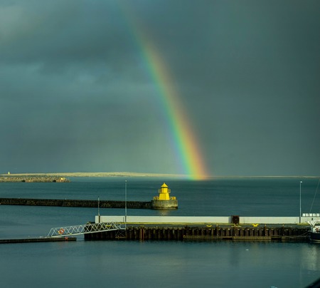 Rainbow with bird in Iceland with clouds skyの写真素材
