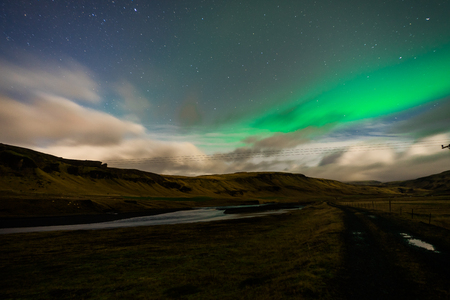 Northern lights Aurora Borealis above landscape in Icelandの写真素材