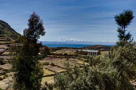 View across La isla del Sol with blue Sky water and trees Lake Tの写真素材