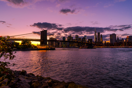 New York Skyline with Brooklyn Bridge Hudson River Manhatten Sunの写真素材