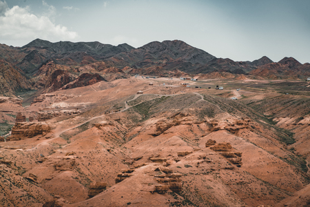 Charyn Grand Canyon with clouds and sun red orange stone Martian landscapeの写真素材