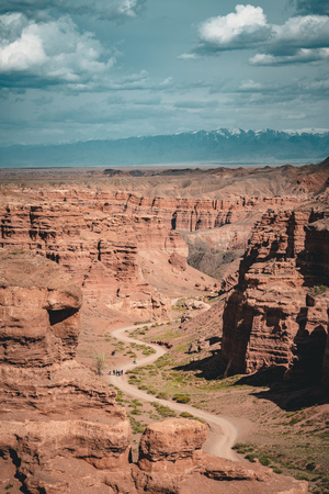 Charyn Grand Canyon with clouds and sun red orange stone Martian landscapeの写真素材