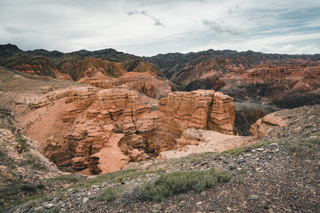 Charyn Grand Canyon with clouds and sun red orange stone Martian landscapeの写真素材