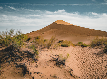 Sand dunes under blue sky. Sahara Desert, Previously, village houses transferred due to sands movement.の写真素材