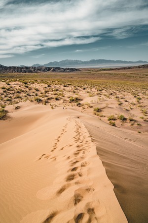 Sand dunes under blue sky. Sahara Desert, Previously, village houses transferred due to sands movement.の写真素材