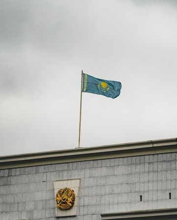 Flag of Kazakhstan on a cludy day on top of a buildingの写真素材