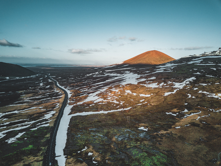 Aerial drone photo of a empty lake and street highway 1 with a huge volcanic mountain Snaefellsjokull in the distance, Reykjavik, Iceland.の写真素材