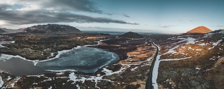 Aerial drone photo of a empty lake and street highway 1 with a huge volcanic mountain Snaefellsjokull in the distance, Reykjavik, Iceland.の写真素材