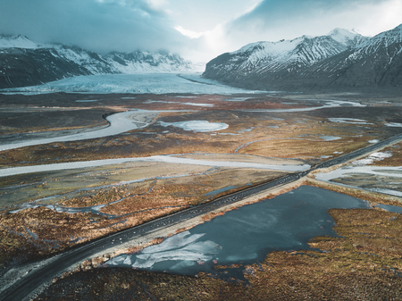 Vatnajokull glacier aerial drone image with street highway and clouds and blue sky. Dramatic winter scene of Vatnajokull National Park, Iceland, Europe. Beauty of nature concept background.の写真素材