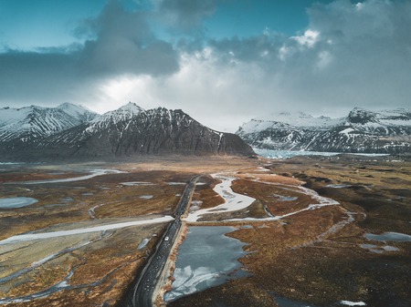 Vatnajokull glacier aerial drone image with street highway and clouds and blue sky. Dramatic winter scene of Vatnajokull National Park, Iceland, Europe. Beauty of nature concept background.の素材 [FY310105466665]