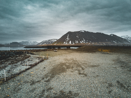 Iceland aerial view Landscape with snow and clouds, street and yellow and green grassの写真素材