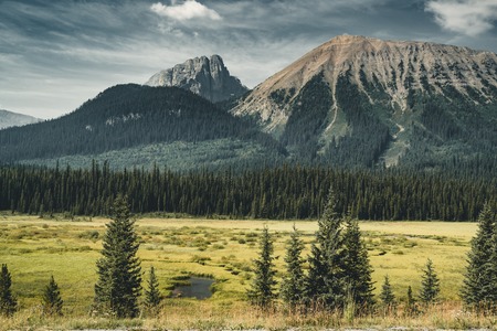 Isolated Peak and surrounding mountains and forests in Banff National Park in the Rocky Mountains in Alberta, Canada.の写真素材