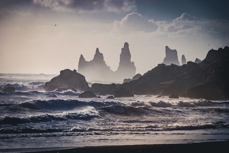 Sunrise at famous Black Sand Beach Reynisfjara in Iceland. Windy Morning. Ocean Waves. Colorful Sky. Morning Sunset. Photo taken in Iceland.の写真素材