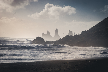 Sunrise at famous Black Sand Beach Reynisfjara in Iceland. Windy Morning. Ocean Waves. Colorful Sky. Morning Sunset.の写真素材