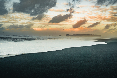 Sunrise at famous Black Sand Beach Reynisfjara in Iceland. Windy Morning. Ocean Waves. Colorful Sky. Morning Sunset.の写真素材