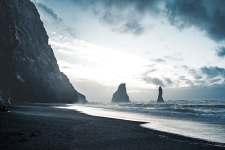 Sunrise at famous Black Sand Beach Reynisfjara in Iceland. Windy Morning. Ocean Waves. Colorful Sky. Morning Sunset.の写真素材
