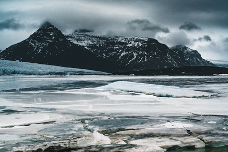 Fjallsarlon Jokulsarlon Huge glacier and mountains in Iceland Vatnajokull glacier aerial drone image with clouds and blue sky. Dramatic winter scene of Vatnajokull National Park, Iceland, Europe. Beauty of nature concept background.の写真素材