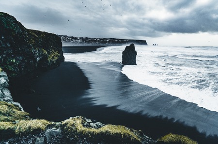 Sunrise at famous Black Sand Beach Reynisfjara in Iceland. Windy Morning. Ocean Waves. Colorful Sky. Morning Sunset.の写真素材