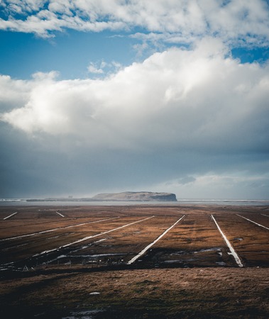 Panoramic view of the Vik at sunrise sunset . South Iceland.Typical red colored wooden church in Vik town, Iceland in winter.の写真素材
