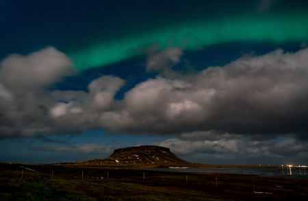 Northern lights aurora borealis appear over Mount Kirkjufell in Iceland.の写真素材