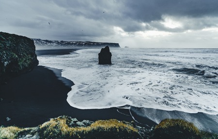 Sunrise at famous Black Sand Beach Reynisfjara in Iceland. Windy Morning. Ocean Waves. Colorful Sky....