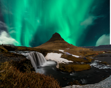Northern lights aurora borealis appear over Mount Kirkjufell in Iceland.の写真素材