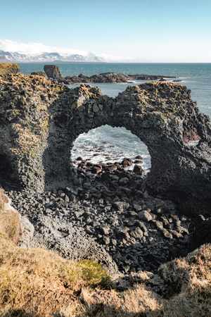 Typical Icelandic sunrise sunset cliff landscape at Arnarstapi area in Snaefellsnes peninsula in Icelandの写真素材