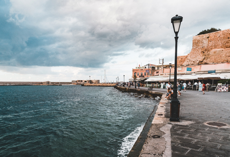 Panorama venetian harbour waterfront and Lighthouse in old harbour of Chania at sunset, Crete, Greeceの写真素材