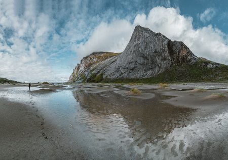 Hiking impressions at Bunes sand beach with view to Bunes Fjorden at Lofoten Islands in Norway on a blue sky with clouds sunny day.の写真素材
