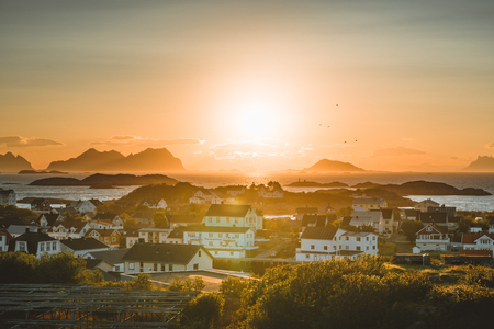 Sunrise and Sunset at Henningsvaer, fishing village located on several small islands in the Lofoten archipelago, Norway over a blue sky with clouds.の写真素材