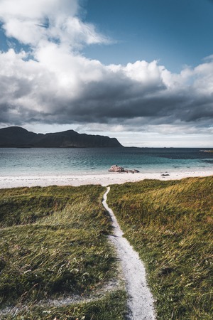 Beautiful clouds on the sky with path leading to the atlantic ocean sea at Ramberg Lofoten Islands, Norway Europeの写真素材