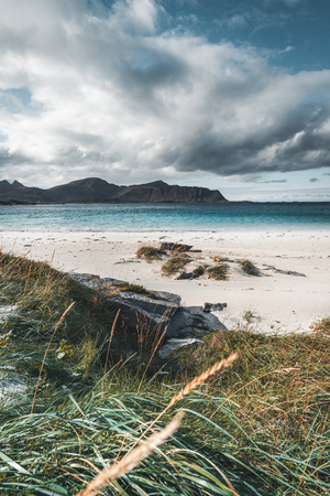 A typical Lofoten beach view frames the sea at Ramberg Lofoten. Scene on a beautiful day with blue...