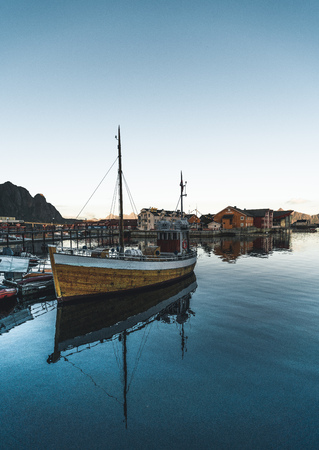 Svolvaer, Norway - September 2018: Boats in the waterfront harbor with mountains in the background. Svolvaer is a fishing village and tourist town located on Austvagoya in the Lofoten Islands.のeditorial素材