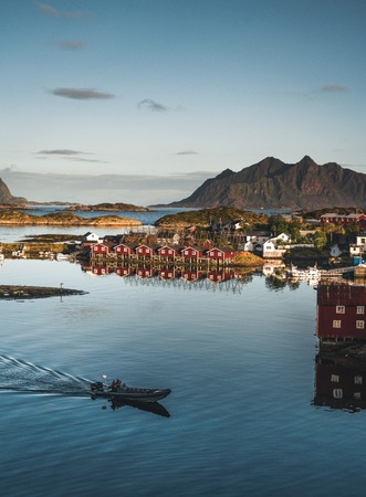 Svolvaer, Norway - September 2018: Boats in the waterfront harbor with mountains in the background. Svolvaer is a fishing village and tourist town located on Austvagoya in the Lofoten Islands.のeditorial素材