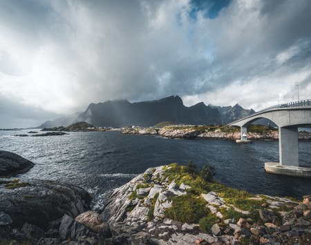 The stunning Hamnoy bridge in Lofoten Islands, Norway seen from a drone aerial. The bridge connects the village of Reine with the village of Hamnoy.の写真素材