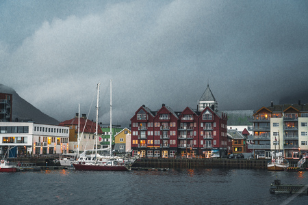 Svolvaer, Norway - September 2018: Boats in the waterfront harbor with mountains in the background. Svolvaer is a fishing village and tourist town located on Austvagoya in the Lofoten Islands.のeditorial素材