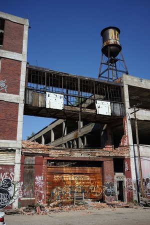 Detroit, Michigan, United States - October 2018: Outside view of the abandoned Packard Automotive Plant with water tower in Detroit. The Packard Plant sprawls multiple city blocks and measures in at 3.5 million square feet. The plant opened in 1903 and clのeditorial素材