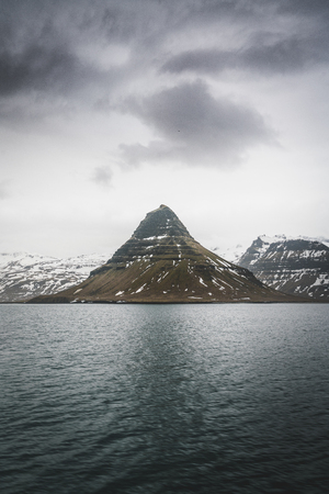 Kirkufell Mountain (Church Mountain in English) overlooking Grundarfjordur Bay on the Snaefellsnes Peninsula in western Iceland.の写真素材