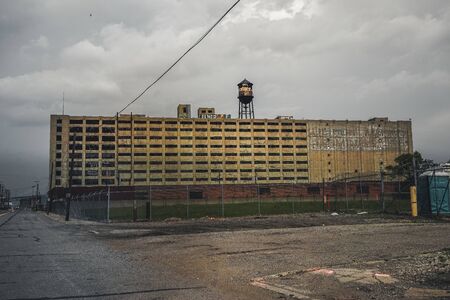Detroit, Michigan, May 18, 2018: View towards abandoned Detroit Automotive Factory with water tower and Chimney.のeditorial素材